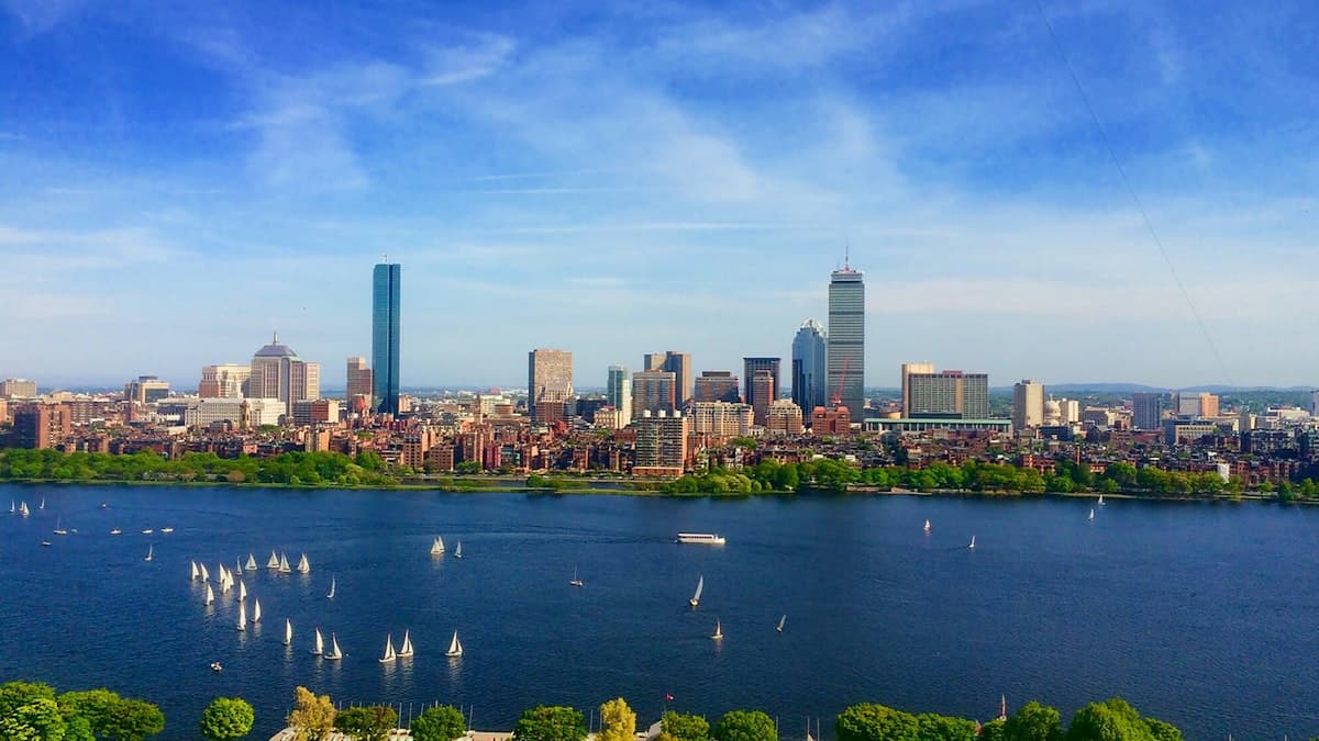 Sailboats on the Charles River in front of Boston's Back Bay skyline and brownstones