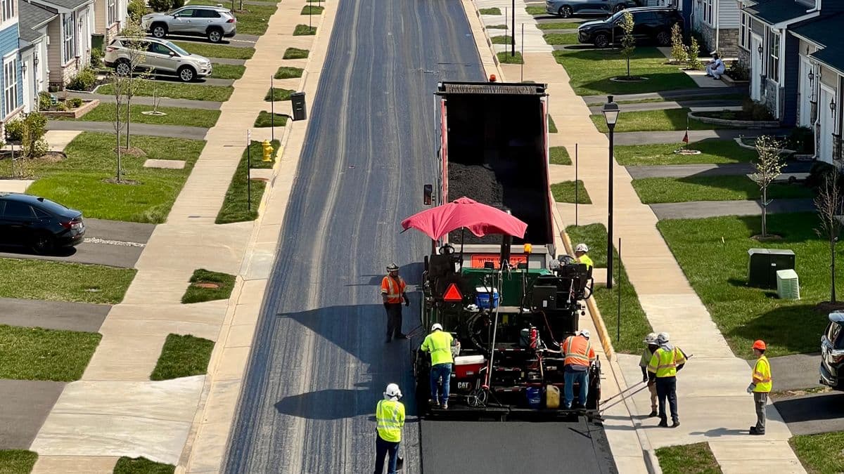 A crew repaving a residential street
