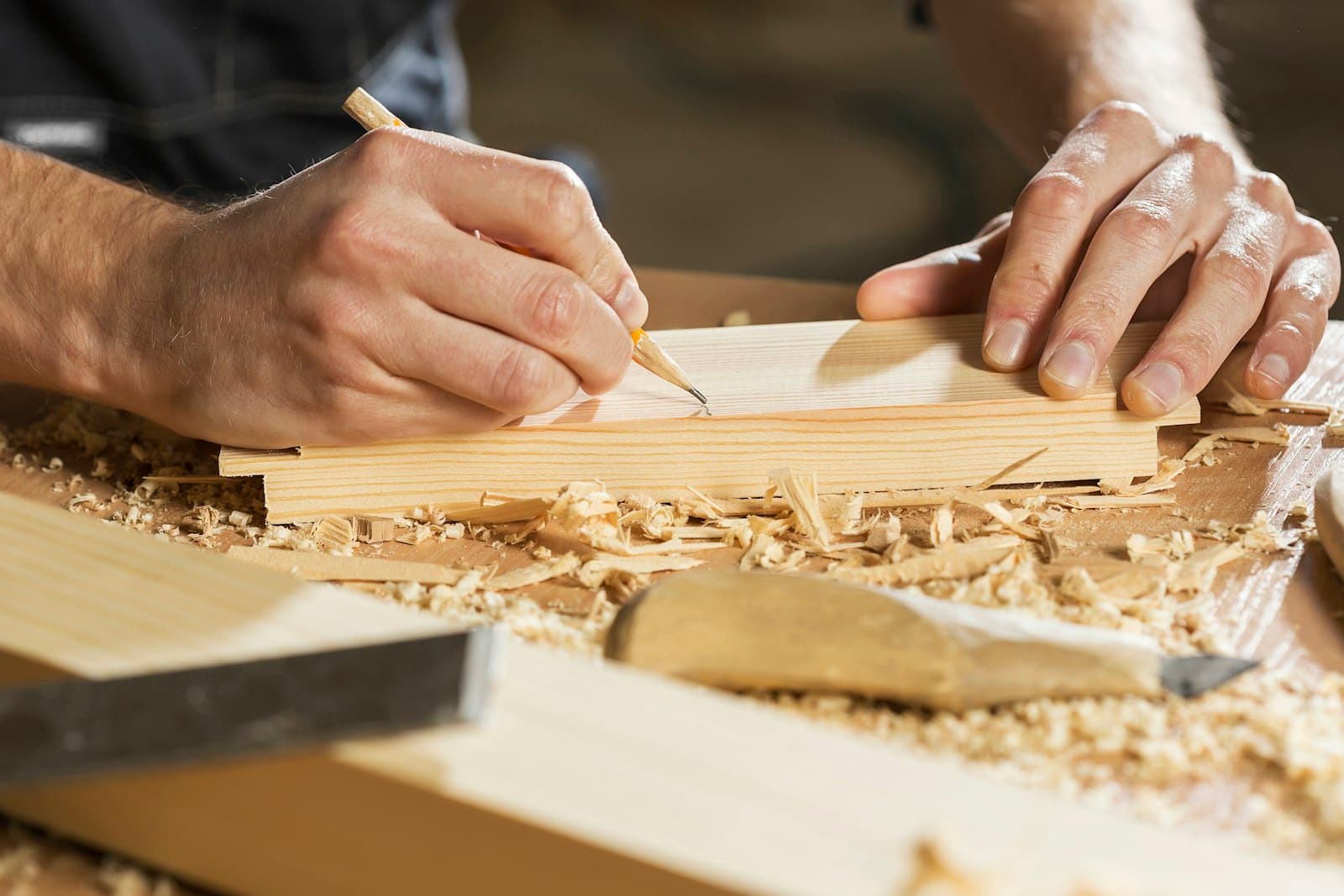A carpenter cutting a piece of wood