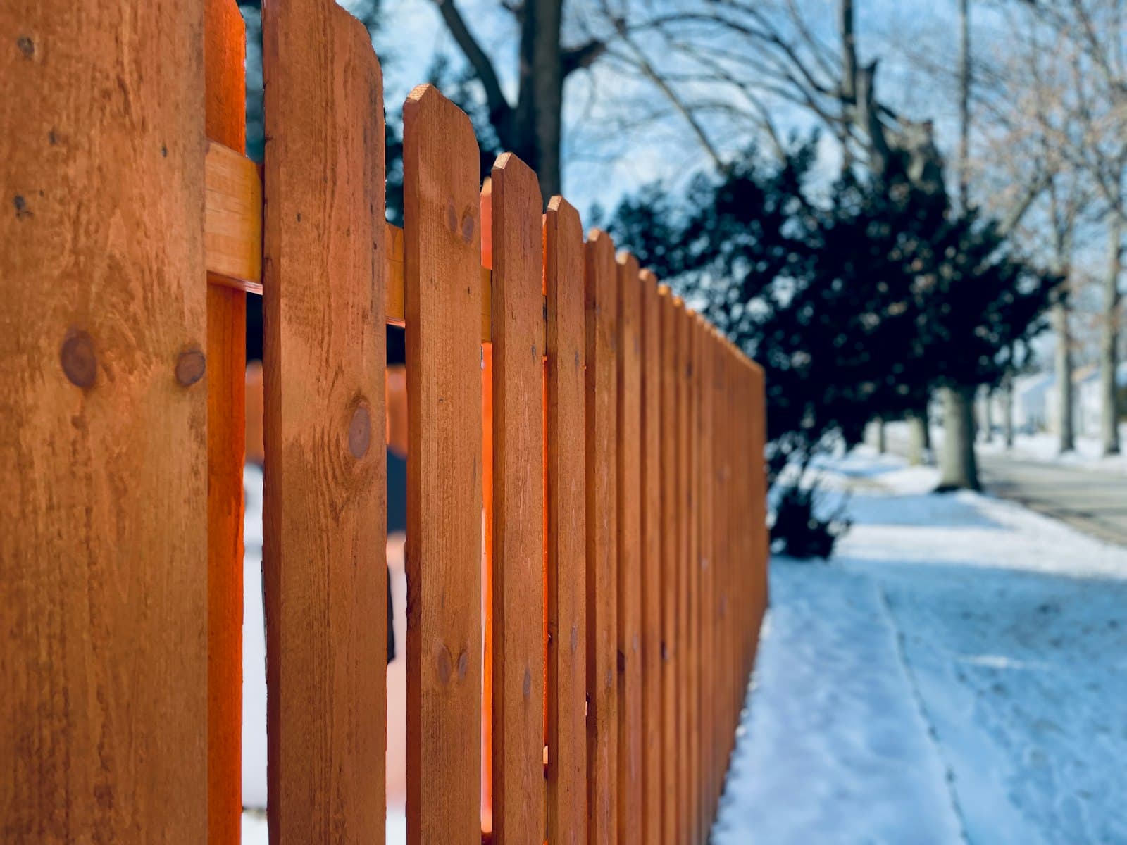A wooden fence line in winter
